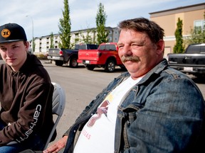 Fort McMurray evacuees Herman Dreier and his son Dominic attend the Best Western Hotel’s pancake breakfast in Stony Plain on Saturday, May 7, 2016. The family fled their home on Tuesday, May 3 and headed north where they had to live out of their camper for three days. They arrived in Stony Plain late in the evening on May 6, after being transported south by an RCMP convoy.  - Photo by Yasmin Mayne