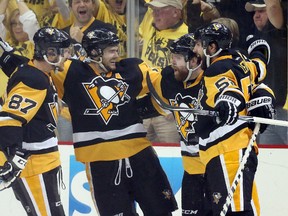 Pittsburgh Penguins centre Sidney Crosby (87) and left wing Chris Kunitz (14) and defenseman Kris Letang (58) congratulate right wing Phil Kessel (RC) after Kessel scored his second goal of the game against the Washington Capitals during the second period in game six of the second round of the 2016 Stanley Cup Playoffs at the CONSOL Energy Center. (Charles LeClaire-USA TODAY Sports)