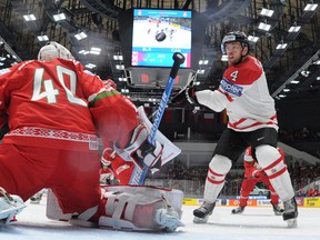 Canada’s Taylor Hall goes to the net as Belarus goaltender Dmitri Milchakov defends during the world championship in St. Petersburg, Russia. (Alexander Nemenov/Pool/AFP)