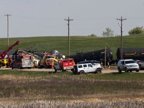 Emergency crews can be seen cleaning up the debris of a train collision-derailment on Highway 893 and Range Road 512 on Friday, May 13. Two people were treated for minor injuries and one person was airlifted to Edmonton, Alta. via STARS. Taylor Hermiston/Vermilion Standard/Postmedia Network.