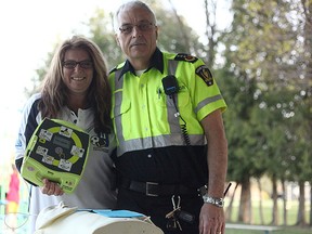 To the left is Krista Granger, the aunt of Andrew Stoddart who died last year of a sudden heart attack while playing soccer. She came to St. Columban May 10 to donate a automated external defibrillator (AED). To the right is Superintendent Paramedic for Huron County's EMS, Art McNaughton. He showed the crowd how to operate the $2,000 machines.(Shaun Gregory/Huron Expositor)