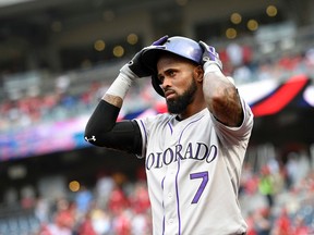 In this Aug. 7, 2015, file photo, Colorado Rockies shortstop Jose Reyes adjusts his batting helmet before a game against the Washington Nationals in Washington. (AP Photo/Nick Wass, File)