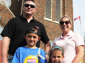 Bricks 4 Kidz franchise owners Steve Devlin and his sister-in-law Celyn Marsh pose with a LEGO windmill, along with Devlin's son Owen, 7, and Marsh's daughter Brooklyn Blackwell, 5. The business includes camps held in Petrolia, and Sarnia's Canon Davis Memorial Church, pictured here. (Tyler Kula, The Observer)