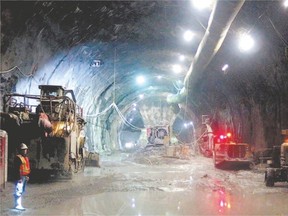 A worker is dwarfed in a tunnel being dug for a station in Ottawa?s light rail system. (Postmedia Network)