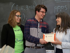 Jolene Hansell, left,  of the Paul Hansell Foundation, Kingston Collegiate Grade 11 student  Matthias Leuprecht and Kingston and the Islands MPP Sophie Kiwala with the ConvoPlate during an event about youth mental healh at Kingston Collegiate on Friday May 13 2016. Ian MacAlpine /The Whig-Standard/Postmedia Network