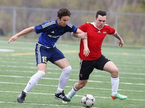 Luca Nardi of the  College Notre Dame Alouettes fights for the ball with Ryan Mooney of the St. Charles Cardinals during senior boys high school soccer action in Sudbury, Ont. on Thursday May 12, 2016. Gino Donato/Sudbury Star/Postmedia Network