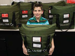 Bright's Grove Public student Evan Duggal shows off the bags of medical supplies he's sent to Zambia through Enactus Lambton. The 11-year-old raised $600 to purchase the basic first aid kits, but he's also on a mission to raise an additional $4,400 to contribute towards the construction of a new medical clinic in the rural village of Gaali. Barbara Simpson/Sarnia Observer/Postmedia Network