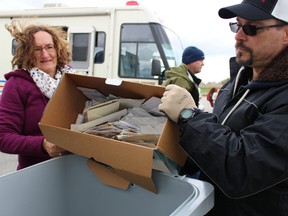 Nelly Kelders, of Bright's Grove, gets a hand from Sarnia police Det. Const. Ken McLachlin in unloading a box of her personal documents for shredding at the Wal-Mart parking lot Saturday. Sarnia police held their popular annual Shred-It event in partnership with Wal-Mart and Shred-It in an effort to prevent cases of identity theft and fraud. "We had people standing at 9:30 a.m. in line faithfully in the rain," McLachlin said of the public response Saturday. Donations were also collected at Saturday's event for Sarnia's upcoming Law Enforcement Torch Run for the Special Olympics. This year's torch run is planned for Wednesday. Participants will take off from the parking lot on the east side of the soccer field underneath the Bluewater Bridge at 10:30 a.m. Barbara Simpson/Sarnia Observer/Postmedia Network