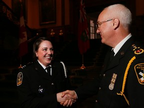Paramedic Eryn Smith of Peel Region Paramedic Services  gets congratulated by Chief Peter Dundas as Ontario recognizes outstanding bravery of paramedics at a ceremony at Queens Park in Toronto  on Thursday May 12, 2016. Stan Behal/Toronto Sun/Postmedia Network