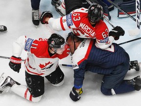 Slovakia’s Andrej Sekera, right bottom, is double-teamed by Canada’s Brad Marchand, above, and  Brendan Gallagher during the world championship in St.Petersburg, Russia, Saturday, May 14, 2016. (AP Photo/Dmitri Lovetsky)