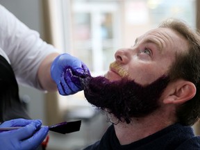Trevor Gregory gets his beard dyed purple as part of a fundraising effort for a young boy with autism, on Saturday May 14, 2016 in Belleville, Ont. 
Emily Mountney-Lessard/Belleville Intelligencer/Postmedia Network