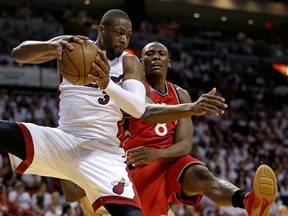 Miami Heat’s Dwyane Wade (3) grabs a rebound away from Toronto Raptors’ Bismack Biyombo (8) during Game 6 of the NBA Eastern Conference semifinals Friday, May 13, 2016, in Miami. (AP Photo/Alan Diaz)