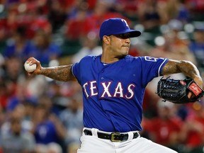 Texas Rangers relief pitcher Matt Bush, a former No. 1 pick, throws his first pitch in the majors, in the ninth inning against the Blue Jays on Friday in Arlington, Texas. (AP/PHOTO)