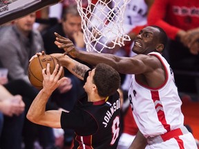 Toronto Raptors centre Bismack Biyombo (8) fouls Miami Heat guard Tyler Johnson (8) during NBA playoff action in Toronto on Wednesday, May 11, 2016. (THE CANADIAN PRESS/Nathan Denette)