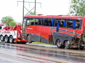 A damaged OGA Charters bus is hauled away after a fatal rollover on Saturday, May 14, 2016, south of the Dimmit-Webb County line on U.S. 83 North in Texas. (Danny Zaragoza/Laredo Morning Times)