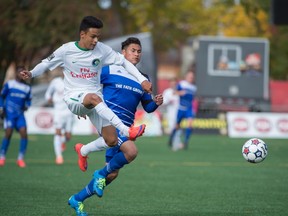 EDMONTON, AB. SEPTEMBER 27, 2015 - Dustin Corea of FC Edmonton, chases David Diosa of the New York Cosmos at Clarke Stadium in Edmonton.