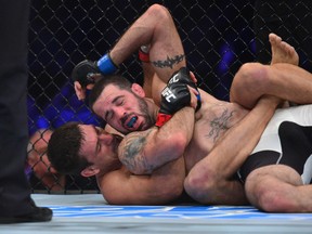 Matt Brown (blue) attempts to escape a choke hold by Demian Maia (red) during UFC 198 Saturday at Arena Atletico Paranaense in Curitiba, Brazil. (Jason Silva/USA TODAY Sports)
