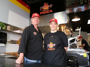 Rob Chaput, left, co-founder of Fired Up Pizza,  and MJ Pappin-Lamoureux, owner/operator of the Fired Up Pizza location in Azilda, Ont., show off the new location on Friday May 13, 2016. There will soon be five Fired up Pizza locations in Greater Sudbury. There are mobile locations on  Barrydowne Road and the Lorne Street location, which will be opening soon for a second season, as well as a location at the Taphouse Northern Grill & Pub on Regent Street, the Azilda site that opened April 29, and the newest location in Lively, which is set to open on May 17. John Lappa/Sudbury Star/Postmedia Network