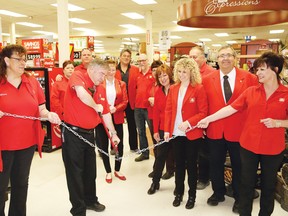 Graham Pitman, second left, the new dealer-owner of the Hanmer Home Hardware, cuts a chain at the grand opening celebration at the Hanmer Home Hardware location at the Hanmer Valley Shopping Centre in Greater Sudbury, Ont. on Friday May 13, 2016. Looking on is Julie Pouliot, third right, board director of Home Hardware stores, and Brian Cook, second right, Northern Ontario area manager of Home Hardware. The store has been renovated, and it features a larger product selection. John Lappa/Sudbury Star/Postmedia Network