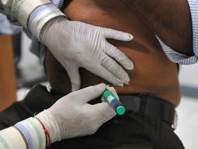 A medical assistant administers an insulin shot to a diabetes patient. (SAJJAD HUSSAIN/AFP/Getty Images)