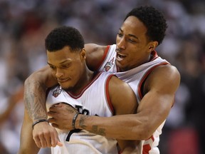 Toronto Raptors' DeMar DeRozan, right, and Kyle Lowry celebrate during  a time out in the fourth quarter of Eastern Conference semifinal NBA playoff basketball action against the Miami Heat in Toronto on Sunday, May 15, 2016. (THE CANADIAN PRESS/Frank Gunn)