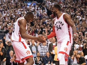 Toronto Raptors center Bismack Biyombo celebrates scoring a basket with forward Patrick Patterson during the fourth quarter in game seven of the second round of the NBA Playoffs against the Miami Heat at Air Canada Centre. (Nick Turchiaro/USA TODAY Sports)
