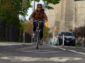 Columnist Sue-Ann Levy rides her bike on the designated cycling lanes on Harbord St. (DAVE ABEL, Toronto Sun)