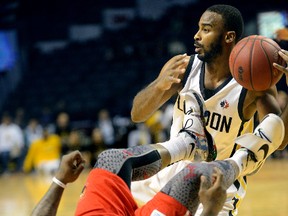 London Lightning guard Akeem Scott battles for a loose ball with Windsor Express point guard Sherron Collins during the first half of a National Basketball League of Canada game at Budweiser Gardens in London, Ontario on Sunday. (MORRIS LAMONT, The London Free Press)