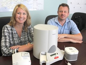 Michelle Shepherdson, left, and George Semple, from Lifeline, an emergency response system that operates through Community and Primary Health Care, show a new medication dispensing service as well as a new wireless emergency response system. Michael Lea The Whig-Standard Postmedia Network