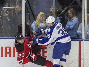 Marlies forward Matt Frattin lays out the Albany Devils’ Vojtech Mozik during Game 6 on Saturday. Frattin, who is actually property of the Ottawa Senators, would no doubt like to play a role in Game 7 tonight at Ricoh Coliseum. (Ernest Doroszuk/Toronto Sun)
