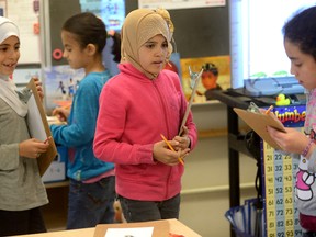 Former Syrian refugee students Shaimaa Alsis, Nikar Khaled, Sidra Alshalabi, and Maram Aalloulou, l-r,  in a grade 3-4 class at Eagle Heights Public School in London, Ontario on Friday May 13, 2016. (MORRIS LAMONT, The London Free Press)