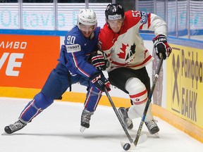 Canada’s Mark Scheifele fights for the puck with France’s Maxime Moisand during Group B action at the world hockey championship in St.Petersburg, Russia on May 16, 2016. (AP Photo/Dmitri Lovetsky)