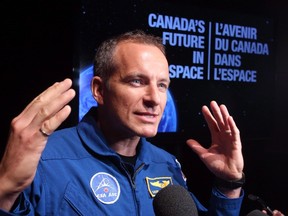 Canadian astronaut David Saint-Jacques speaks to reporters after Industry Minister James Moore announced Canada's commitment to fly two Canadian astronauts to space by 2024 during a news conference in Ottawa Tuesday June 2, 2015. Quebec engineer and doctor Saint-Jacques will be the next Canadian to work in space aboard the International Space Station. THE CANADIAN PRESS/Fred Chartrand