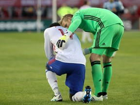 Toronto FC's Jozy Altidore drops to a knee after injuring his hamstring during last Saturday's game in Vancouver.