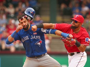 Toronto Blue Jays Jose Bautista gets hit by Texas Rangers second baseman Rougned Odor after Bautista slid into second in the eighth inning of a baseball game at Globe Life Park in Arlington, Texas, on May 15, 2016. (Richard W. Rodriguez/Star-Telegram via AP)