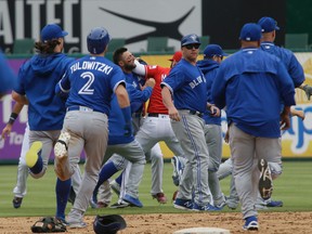 The Texas Rangers and Toronto Blue Jays tussle during the eighth inning of a baseball game in Arlington, Tex., Sunday, May 15, 2016. (AP Photo/LM Otero)