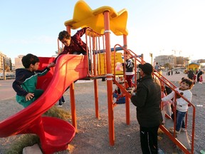 Children play at a playground. (MAHMUD TURKIA/AFP/Getty Images)