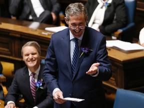 Manitoba Premier Brian Pallister jokes with the speaker of the house after the reading of the provincial throne speech at the Manitoba Legislature in Winnipeg, Monday, May 16, 2016. THE CANADIAN PRESS/John Woods