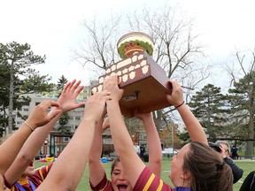 Regipoplis-Notre Dame Panthers captains Annie Kennedy , left, and Mara Medeiros accept the championship trophy after defeating the Napanee Golden Hawks during the KASSAA girls rugby championship at Nixon Field in Kingston on Monday May 16 2016. Ian MacAlpine /The Whig-Standard/Postmedia Network