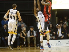 Windsor Express forward Brandon Robinson takes a jump shot over London Lightning forward Eric Kibi  during the first half of a National Basketball League of Canada game at Budweiser Gardens in London, Ontario on Sunday. (MORRIS LAMONT, The London Free Press)