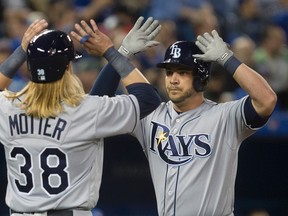 Tampa Bay Rays first baseman Steve Pearce (right) is greeted at home plate by shortstop Taylor Motter after scoring on home run against the Toronto Blue Jays Monday at the Rogers Centre. (Dan Hamilton/USA TODAY Sports)