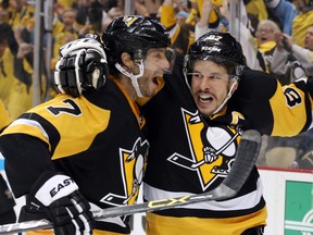 Pittsburgh Penguins centre Matt Cullen (7) and teammate Sidney Crosby celebrate after beating the Tampa Bay Lightning in Game 2 of the Eastern Conference final Monday at the CONSOL Energy Center. (Charles LeClaire/USA TODAY Sports)
