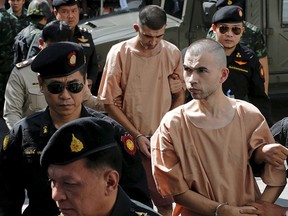 Suspects of the Aug. 17 Bangkok blast, Bilal Mohammed (also known as Adem Karadag) and Yusufu Mieraili are escorted as they arrive at the military court in Bangkok, Thailand, Nov. 24, 2015. REUTERS/Chaiwat Subprasom/File Photo
