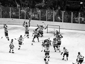 In this Feb. 22, 1980 file photo, the U.S ice hockey team rushes toward goalie Jim Craig after their upset win over the Soviet Union in the final group stage of the  Winter Olympic Games in Lake Placid, N.Y. (AP Photo, File)