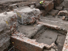 An archaeologist works on the exposed remains as the site of Shakespeare's Curtain Theatre is excavated in Shoreditch in London, Tuesday, May 17, 2016. Archaeologists are excavating the remains of the Curtain, a 16th-century theatre where some of the Bard's plays were staged, before another gleaming tower joins the city's crowded skyline.  (AP Photo/Kirsty Wigglesworth)