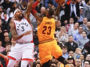 Cavaliers' LeBron James (23) attempts to get by Raptors' James Johnson (3) during NBA action in Toronto on Feb. 26, 2016. (Stan Behal/Toronto Sun)