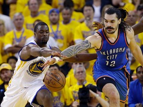 Thunder's Steven Adams (12) fights for a loose ball against Warriors' Harrison Barnes (40) during second half action in Game 1 of the NBA's Western Conference final in Oakland, Calif., on Monday, May 16, 2016. (Marcio Jose Sanchez/AP Photo)