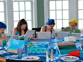 In this photo taken June 7, 2015, Nicole Nussbaum, Katie Pollack, Kristen Nussbaum and Robert Nussbaum paint vacation scenes as part of an "Easel Like Sunday Morning" theme at a vacation home in North Topsail Beach, N.C. (Rob Nussbaum via AP)