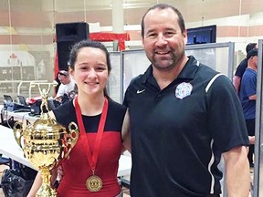 Alana Santavy shows her best lifter trophy alongside her father and coach, Dalas Santavy. Alana, 13, won gold in her weight class and was named the best pound-for-pound female lifter at her first competition. (Handout)