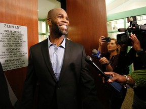John Nolley smiles as he leaves the courtroom following his release from custody, Tuesday, May 17, 2016, at the 213th District Court, in Fort Worth, Texas. Nolley, who had been incarcerated for almost 19 years, was freed after his murder conviction was overturned due to new evidence.  (Paul Moseley /Star-Telegram via AP)